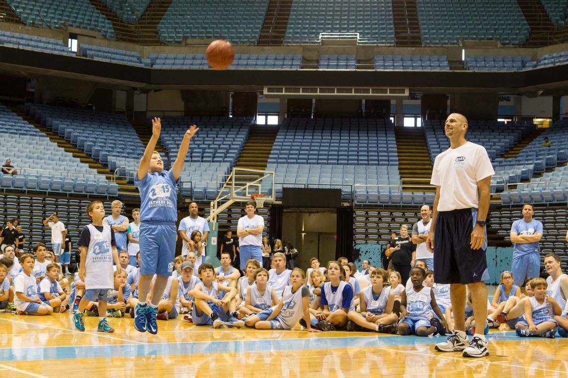 In this 2015 photo, Camper Sam Benjamin puts up his best shot during the 3 point shot competition as Eric Montross looks on at the Eric Montross Father’s Day Basketball Camp. Montross started the camp in the summer of 1994, in part to honor Jason Clark, a teen he befriended at UNC Children’s Hospital.