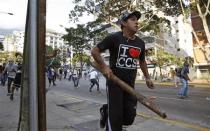 Demonstrators confront police as they protest against the government of President Nicolas Maduro in Caracas February 22, 2014. REUTERS/Carlos Garcia Rawlins