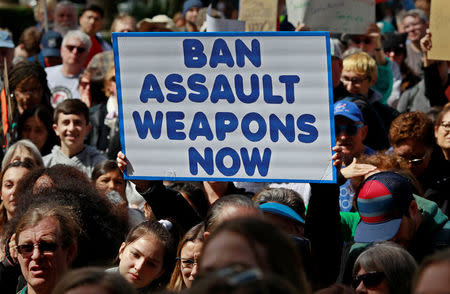 A protestor holds a sign during a "March For Our Lives" demonstration demanding gun control in Sacramento, California, U.S. March 24, 2018. REUTERS/Bob Strong