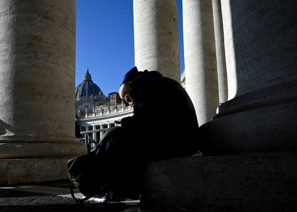 A nun sits under the columns in St Peter’s Square at The Vatican on 28 December 202 (AFP via Getty Images)