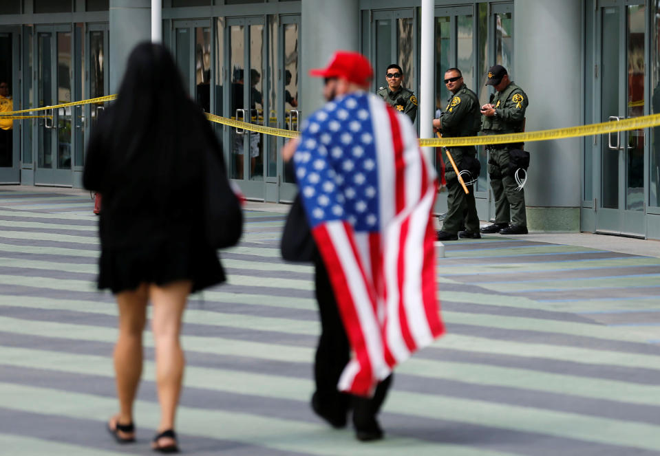 People arrive under the watch of Orange County Sheriff deputies at Anaheim Convention Center, where Republican U.S. Presidential candidate Donald Trump will speak at a campaign event in Anaheim,