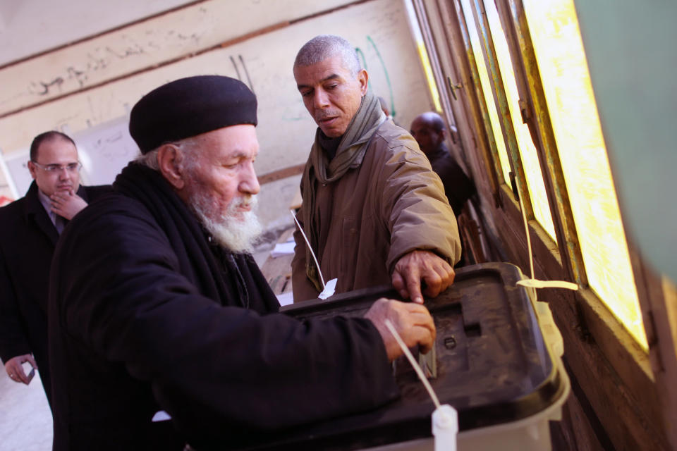 Father Antonious casts his ballot in a constitutional referendum inside a polling station in Dalga village of Minya, Egypt, Wednesday, Jan. 15, 2014. He is one of the priests of the Virgin Mary and St. Abraam Monastery that was looted and burned by supporters of ousted Islamist President Mohammed Morsi in August. Through violence or intimidation, Islamists in villages like this one used violence or intimidation to stop Christians from voting "no" to a 2012 constitution that had paved the way for the creation of an Islamic state. This time around, no one is stopping the Christians and they are voting "yes" on a new charter that criminalizes discrimination and instructs the next legislature to ease restrictions on building churches. (AP Photo/Roger Anis, El Shorouk Newspaper) EGYPT OUT