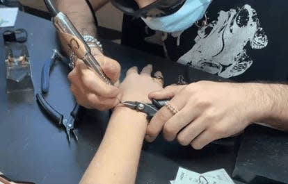 A gif shows the author being "zapped," or having a bracelet welded onto her wrist.