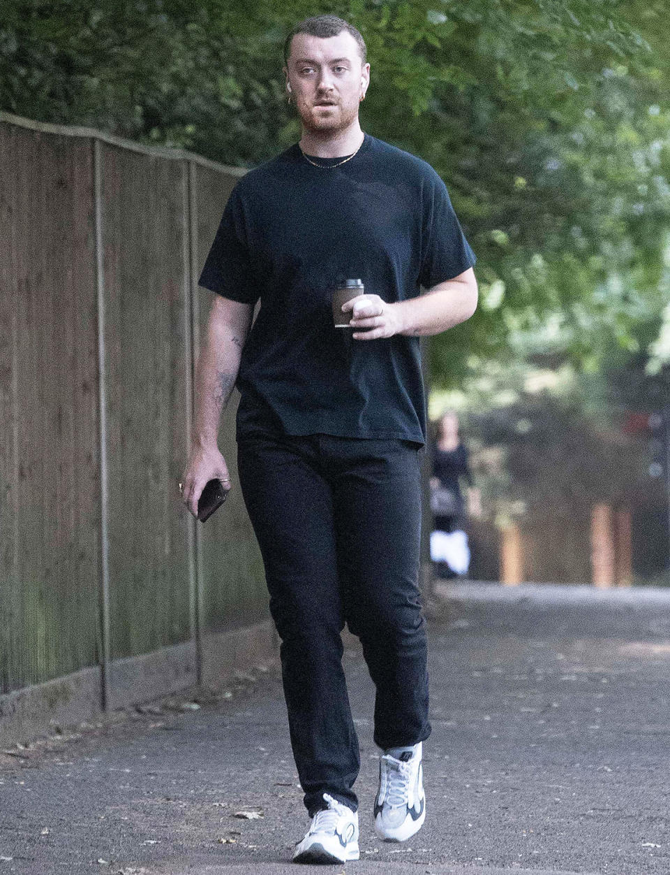 <p>Sam Smith grabs coffee to-go as they make their way through London on Tuesday.</p>