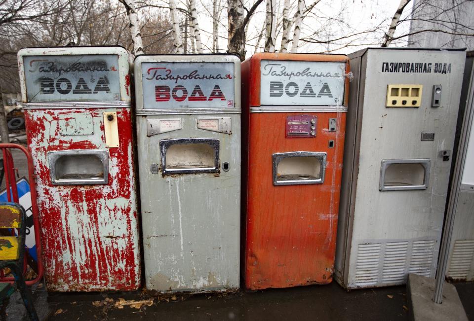 In this photo taken on Sunday, Nov. 3, 2019, Soviet-era soda vending machines are on display in the 'Museum of Industrial Culture' in a dilapidated industrial zone of Moscow, Russia. Moscow’s suburbs are the focus of a major international art exhibition that has just opened in the Russian capital. The exhibit uses contemporary art to explore the many hidden facets of life beyond the Russian capital’s nucleus. Austrian cultural attache says the ‘real’ Moscow where most of the city’s 12.6 million people live, is outside the center. (AP Photo/Alexander Zemlianichenko)