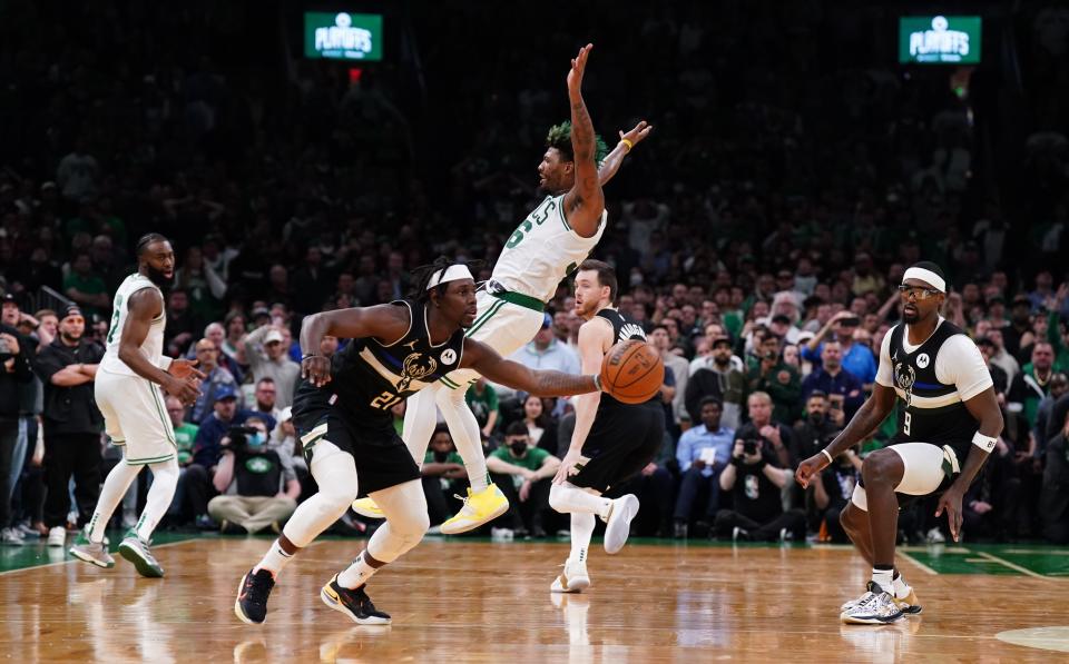 May 11, 2022; Boston, Massachusetts, USA; Milwaukee Bucks guard Jrue Holiday (21) steals the ball from Boston Celtics guard Marcus Smart (36) to end the game in the second half during game five of the second round for the 2022 NBA playoffs at TD Garden. Mandatory Credit: David Butler II-USA TODAY Sports