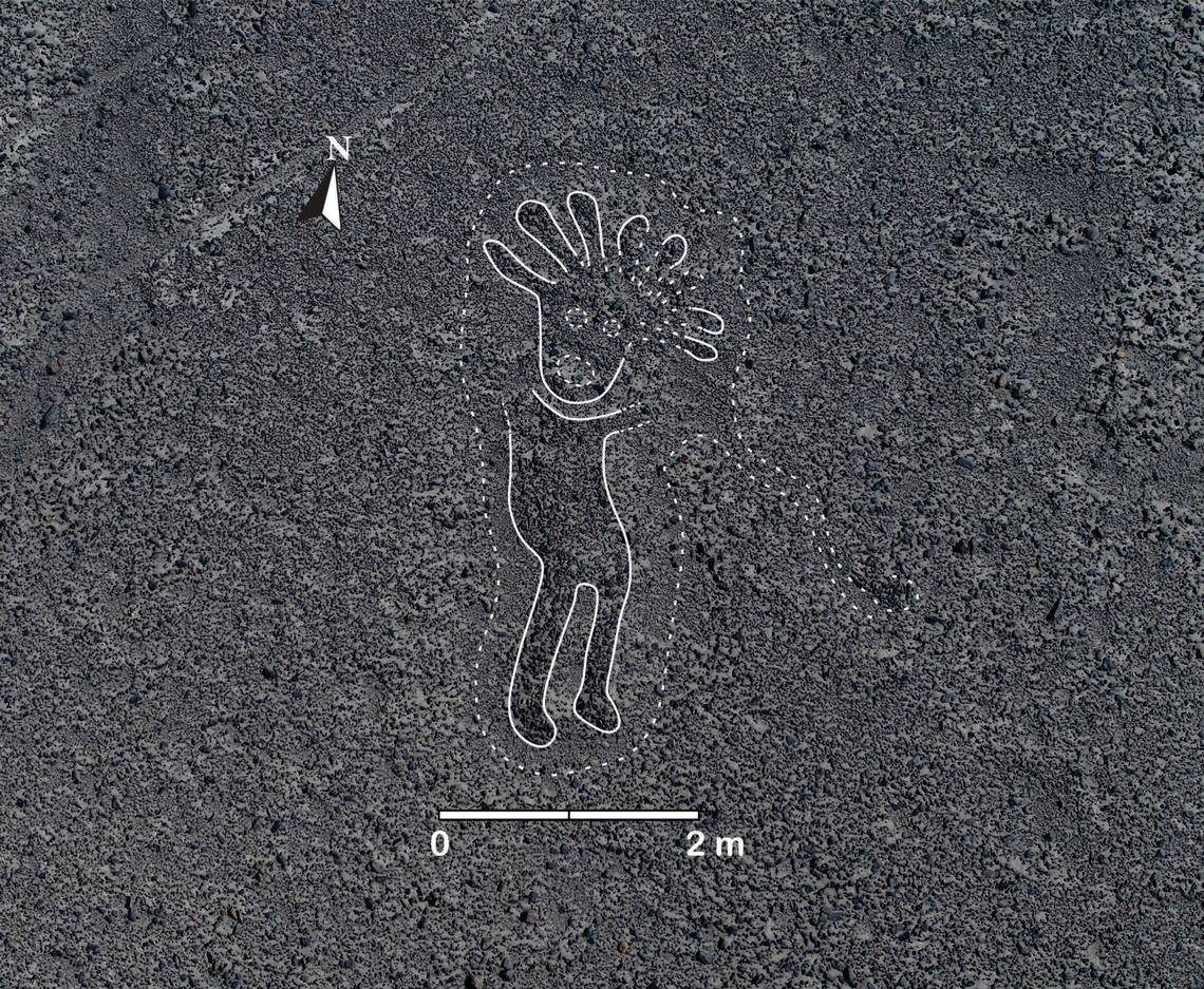 A geoglyph of a human figure. Researchers digitally digitally added white lines to highlight the shape.