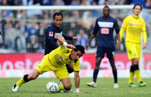 Dortmund's Lucas Barrios (front) and Hertha Berlin's Raffael and during their German league match on February 18. Dortmund picked up their sixth straight league win with a hard-earned victory 1-0 against a Hertha side just above the relegation places