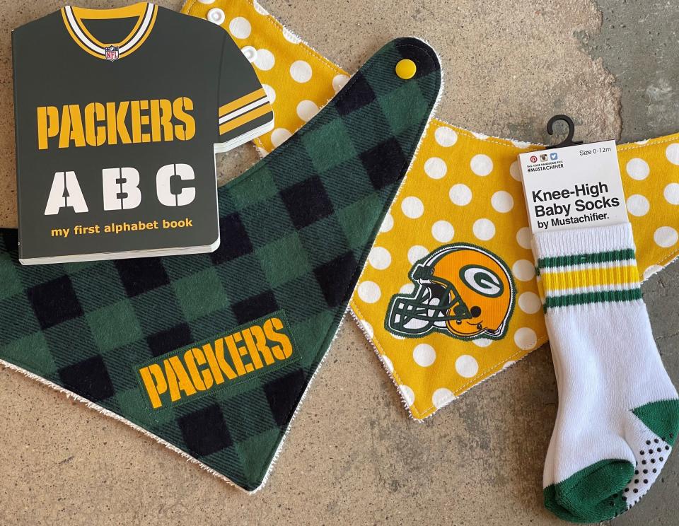 A Packers alphabet book and baby knee-highs from The Puddle Duck in De Pere are Molly Crosby's go-to baby gift. The store also has other green and gold items, including bibs.