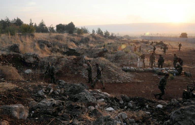 A handout picture released by the official Syrian Arab News Agency (SANA) shows Syrian army units and pro-government forces holding a position at an undisclosed location in western Syria on October 8, 2015