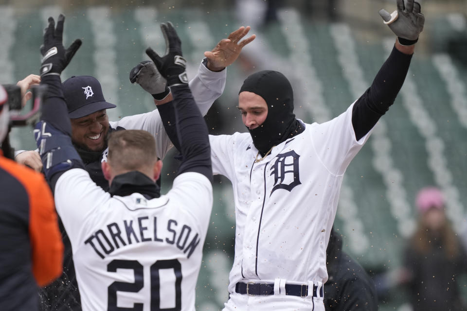 Detroit Tigers' Kerry Carpenter, right, is greeted by teammates after his game winning home run during the ninth inning in the first game of a baseball doubleheader against the Cleveland Guardians, Tuesday, April 18, 2023, in Detroit. (AP Photo/Carlos Osorio)