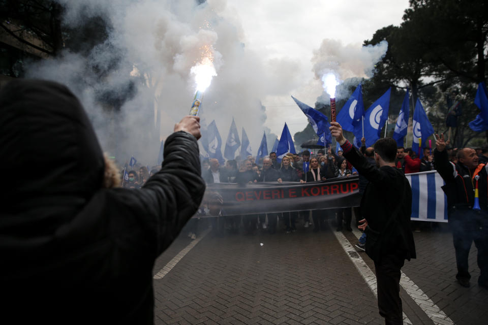 Protester hold flares as they take part in an anti-government protest in the capital Tirana, Saturday, April 13, 2019. Albanian opposition parties have returned to the streets for the first time since mid-February calling for the government's resignation and an early election, as the center-right opposition accuses the leftist Socialist Party government of Prime Minister Edi Rama of corruption and links to organized crime, which the government denies. (AP Photo/Visar Kryeziu)