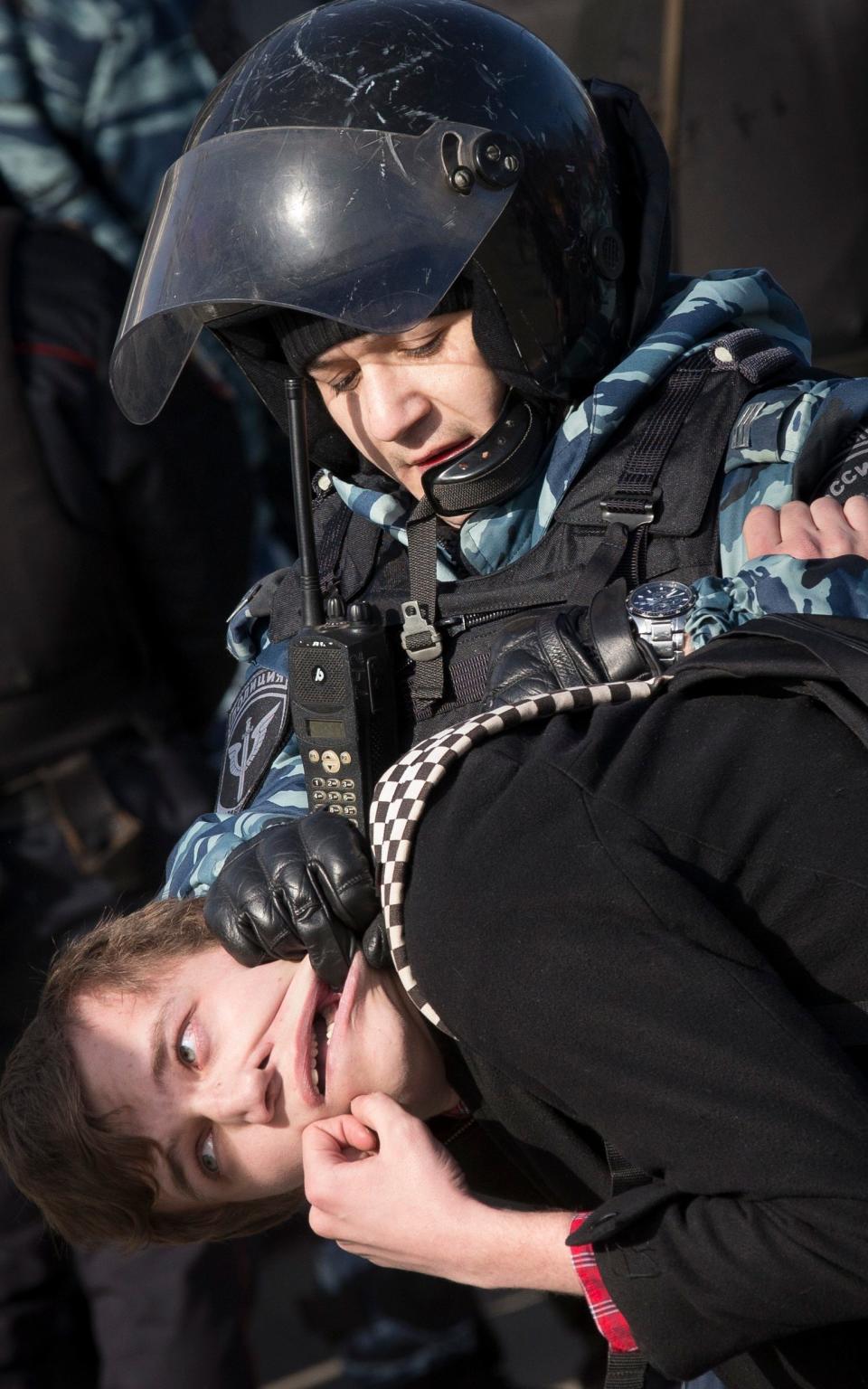 Police detain a protester in Moscow, - Credit:  Alexander Zemlianichenko/ AP