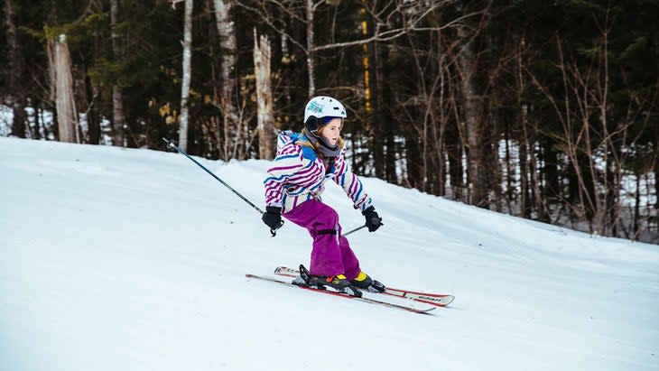 Little girl skiing down a mountain