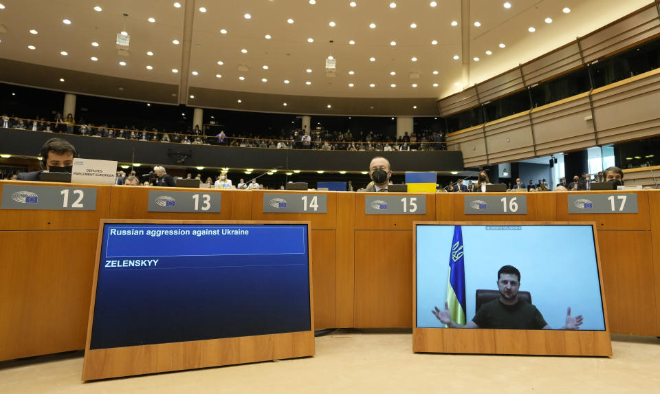 FILE - Ukraine's President Volodymyr Zelenskyy addresses the Plenary, via remote link, during an extraordinary session on Ukraine at the European Parliament in Brussels, March 1, 2022. European Union leaders gather in Versailles for a two-day summit focusing on the war in Ukraine. Their nations have been fully united in backing Ukraine’s resistance with unprecedented economic sanctions, but divisions have started to surface on how fast the bloc could move in integrating Ukraine and severing energy ties with Moscow. (AP Photo/Virginia Mayo, File)