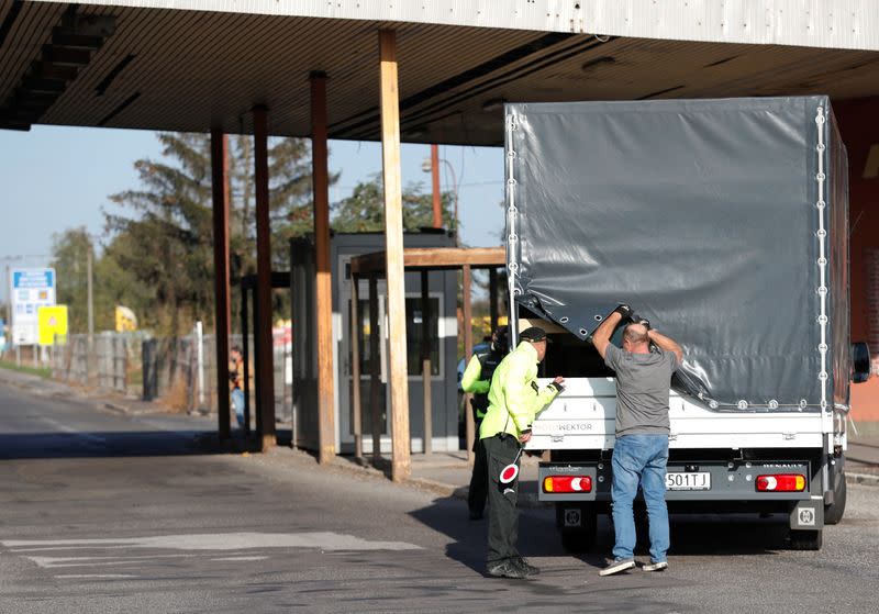 Slovakian police check a vehicle at the Slovakia-Hungary border in Sahy