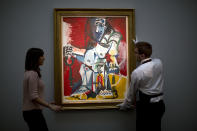 <p>Sotheby’s auction house staff pose for photographs with Spanish artist Pablo Picasso’s “Femme nue Assise” during a photocall at Southeby’s auction house in London, Feb. 22, 2017. The painting is estimated to fetch between 9.5 and 12 million pounds (between $12 and $13 million) in an “Impressionist and Modern Art Sale” in London on March 1. (Photo: Matt Dunham/AP) </p>