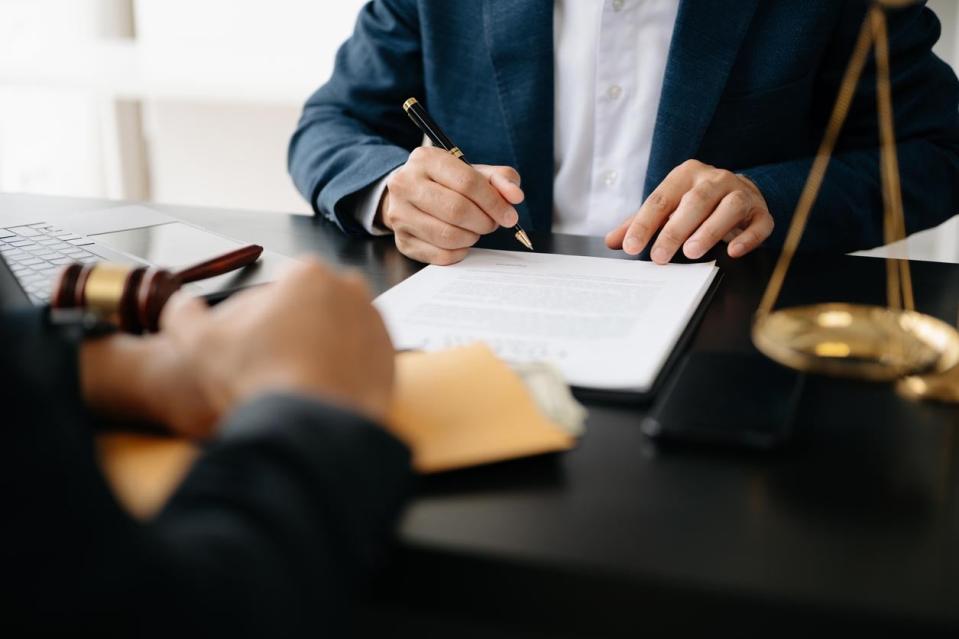 A close up of a person signing a document. 