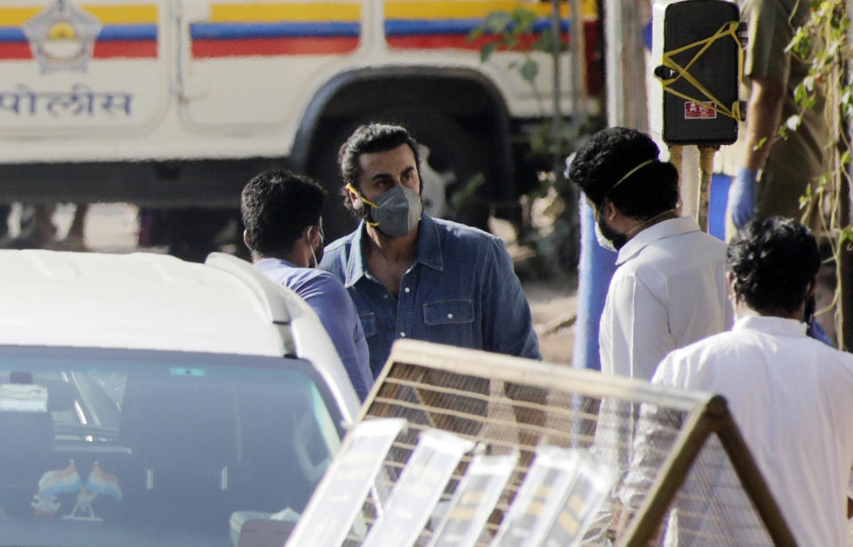Bollywood actor Ranbir Kapoor, facing camera, speaks with Abhishek Bachchan after the cremation of his actor father Rishi Kapoor in Mumbai, India, Thursday, April 30, 2020. Top Indian actor Rishi Kapoor, a scion of Bollywood’s most famous Kapoor family, has died. He was 67 and had leukemia. (AP Photo/Rajanish Kakade)