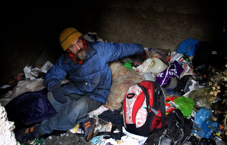 Homeless Bratislav Jovanovic hunkers down inside a grave on January 10, 2013. He lives there during the harsh Serbian winter. Only twelve towns in Serbia have homeless shelters, but these cannot keep up with demand, a homeless volunteer said