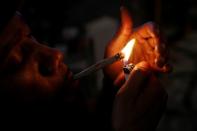 FILE PHOTO: Cannabis entrepreneur Fetti smokes a hybrid strain joint of his marijuana brand "PowerPuff" in the Queens borough of New York