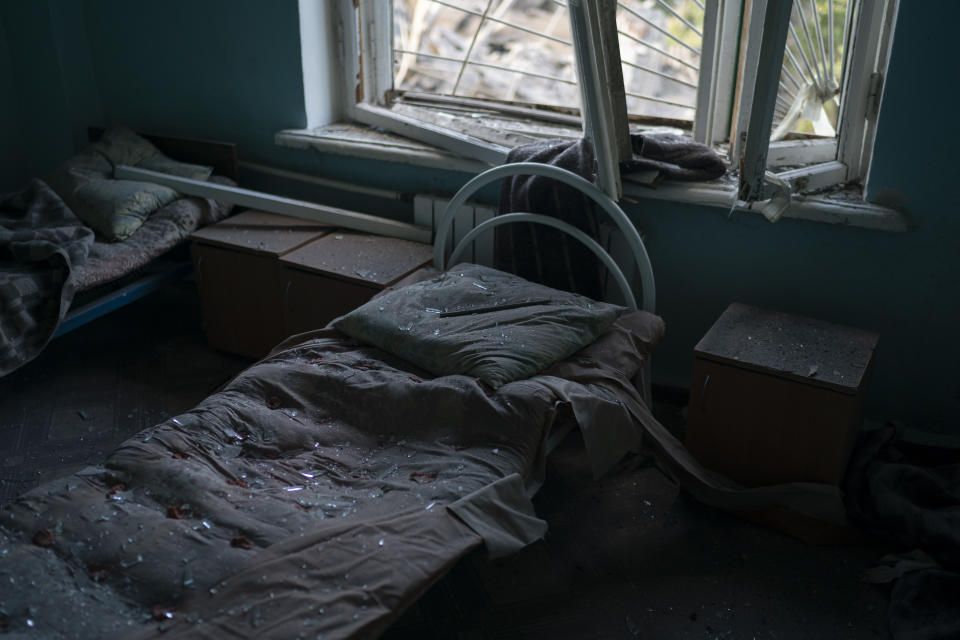 FILE - A bed is seen covered with shattered glass from a broken window of a psychiatric hospital that was heavily damaged after a Russian attack in Kramatorsk, Ukraine, Sept. 7, 2022. In December, the World Health Organization said one in five people in countries that have experienced conflict in the past decade will suffer from a mental health condition, and estimated that about 9.6 million people in Ukraine could be affected. Russia’s invasion in February 2022 resulted in millions of people being displaced, bereaved, forced into basements for months due to incessant shelling or enduring harrowing journeys from Russian-occupied regions. (AP Photo/Leo Correa, File)