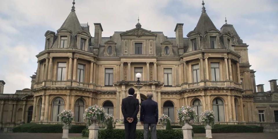 a couple of men standing in front of a large building with rippon lea estate in the background