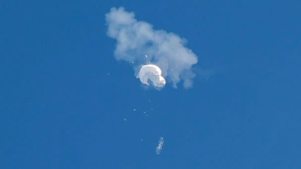 PHOTO: The suspected Chinese spy balloon drifts to the ocean after being shot down off the coast in Surfside Beach, S.C., Feb. 4, 2023. (Randall Hill/Reuters)