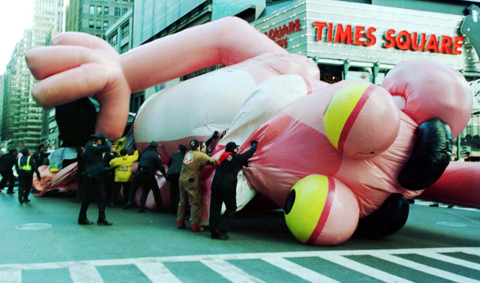 A Pink Panther. balloon falls to the ground at the 1997 Macy's thanksgiving day parade.