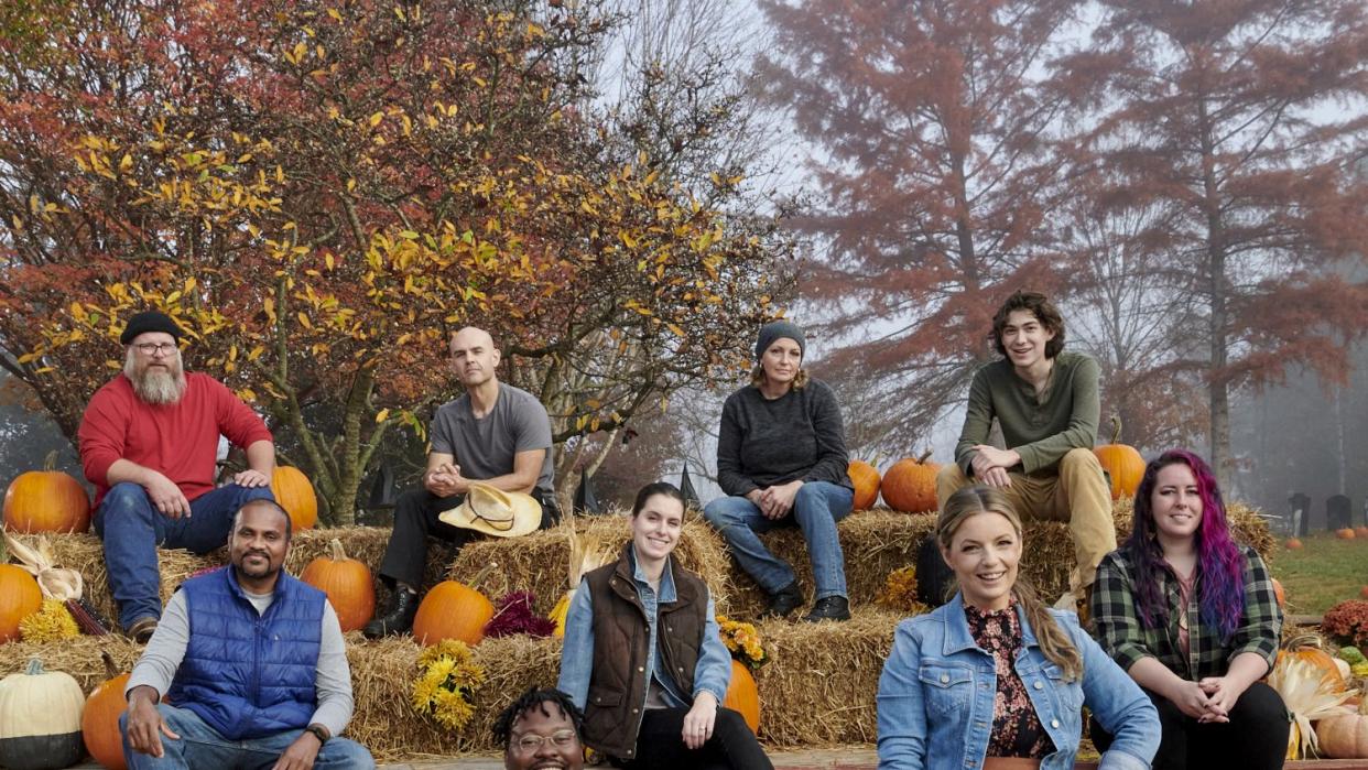 group portrait of contestants daniel miller, james hall, michele vanderpyle hall, and anderson, chaminda weerappulgie, cassie remillard, rebecca degroot and arthur romeo with host damris phillips as seen on outrageous pumpkins season 4