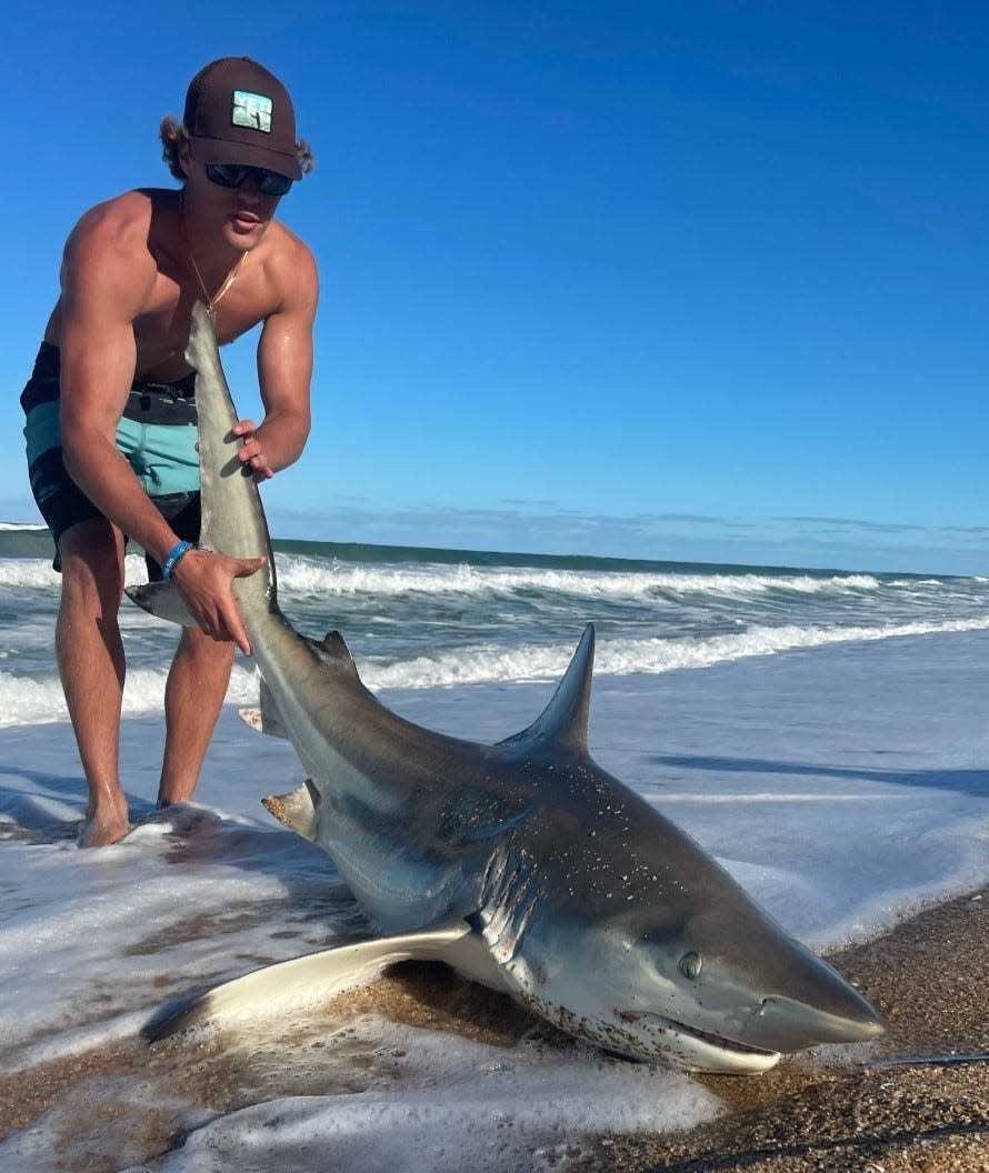 That's Carson preparing to release a 6-foot blacktip he caught with the help of New Smyrna Shark Hunters.