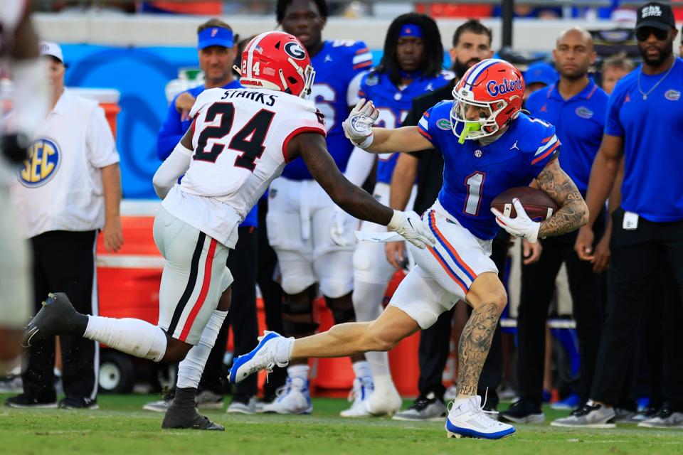 Florida Gators wide receiver Ricky Pearsall (1) is pressured out of bounds by Georgia Bulldogs defensive back Malaki Starks (24) during the third quarter of an NCAA football game Saturday, Oct. 28, 2023 at EverBank Stadium in Jacksonville, Fla. Georgia defeated Florida 43-20. [Corey Perrine/Florida Times-Union]