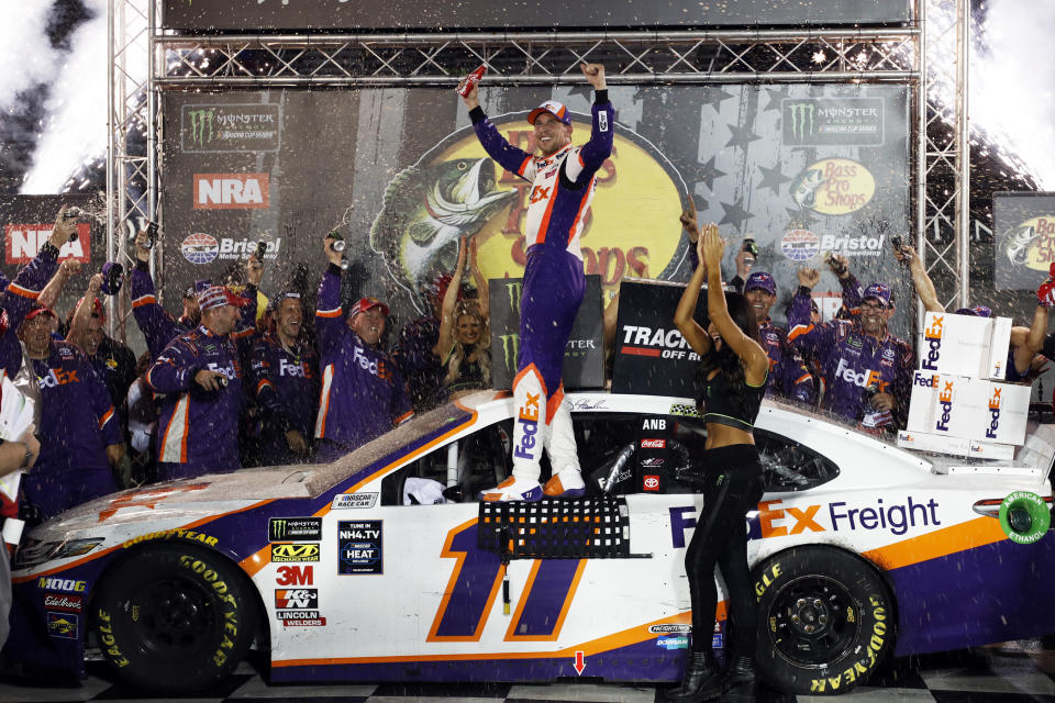 Denny Hamlin, center, celebrates after winning a NASCAR Cup Series auto race Saturday, Aug. 17, 2019, in Bristol, Tenn. (AP Photo/Wade Payne)