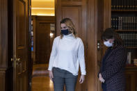 Greek President Katerina Sakellaropoulou welcomes Olympic sailing champion Sofia Bekatorou, left, at the Presidential Palace in Athens, Monday, Jan. 18, 2021. Bekatorou has accused an unnamed sporting official of sexually assaulting her in 1998 during preparations for the Sydney Games. Bekatorou made the allegation Thursday Jan. 14, 2021 while speaking at an online event organized by the ministry of culture and sport. (Alkis Konstantinidis /Pool via AP)