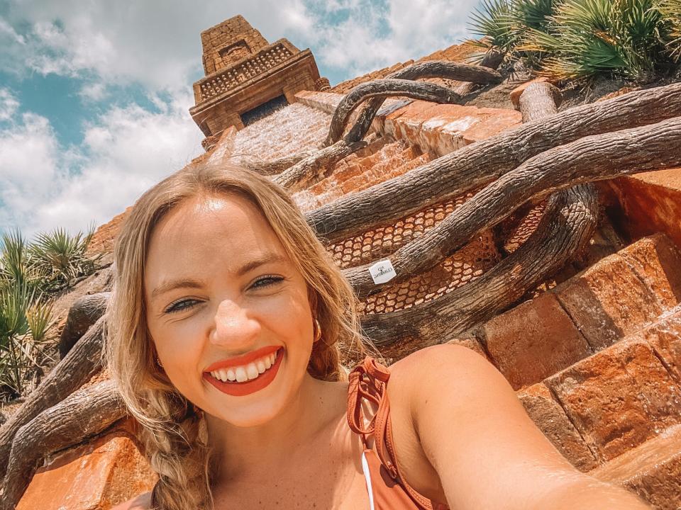 kayleigh taking a selfie in front of the Mayan ruin pool at disney's coronado springs resort