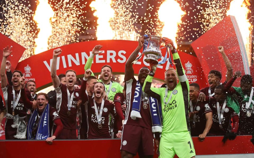 Leicester's goalkeeper Kasper Schmeichel, right, and Leicester's Wes Morgan lift the trophy after winning the FA Cup final soccer match between Chelsea and Leicester City  - PA