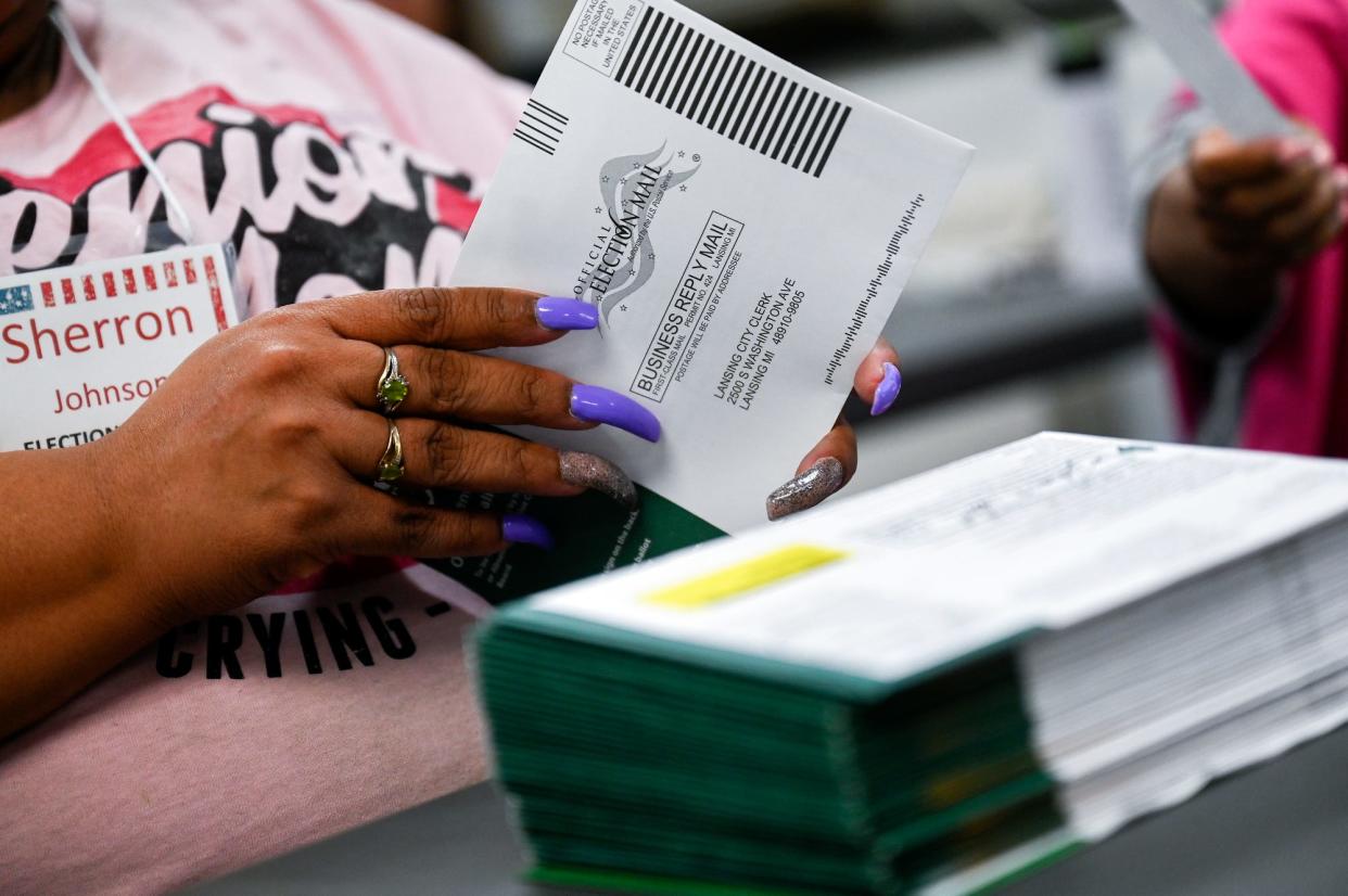 Election worker Sherron Johnson processes ballots at the Lansing City Clerk's Election Unit after the polls closed on Tuesday, Nov. 8, 2022, in Lansing.