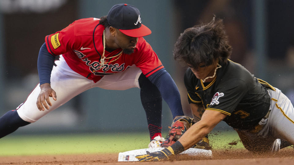 Pittsburgh Pirates' Ji Hwan Bae arrives at second with a double, as Atlanta Braves second baseman Ozzie Albies applies a late tag during the first inning of a baseball game Friday, Sept. 8, 2023, in Atlanta. (AP Photo/Hakim Wright Sr.)