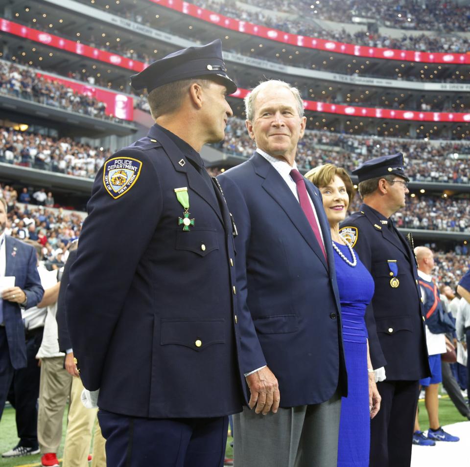 <p>Former president George W. Bush and his wife Laura join two New York City Police officers in the pregame ceremony as the New York Giants play the Dallas Cowboys on Sunday, Sept. 11, 2016 at AT&T Stadium, in Arlington, Texas. (Rodger Mallison/Fort Worth Star-Telegram/TNS via Getty Images) </p>