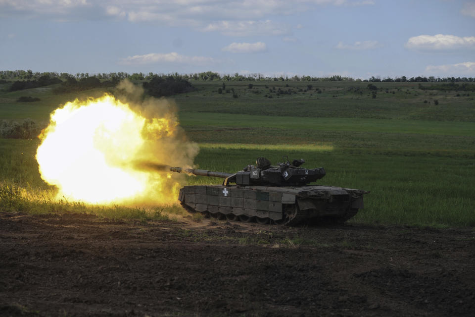 A Ukrainian tank fires in Chasiv Yar, the site of fierce battles with the Russian forces, Ukraine, Wednesday, June 7, 2023. (Iryna Rybakova via AP)