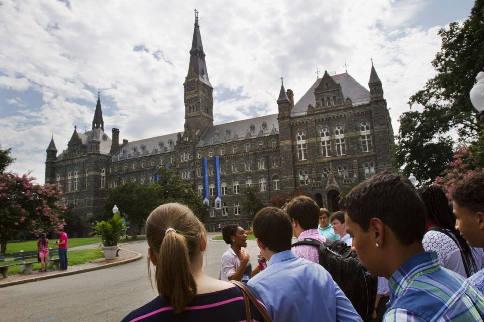 FILE - In this July 10, 2013, file photo, prospective students tour Georgetown University's campus in Washington, D.C. High school seniors are now playing the waiting game on college acceptance letters.