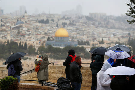 People stand at an observation point overlooking the Dome of the Rock and Jerusalem's Old City December 6, 2017. REUTERS/Ammar Awad