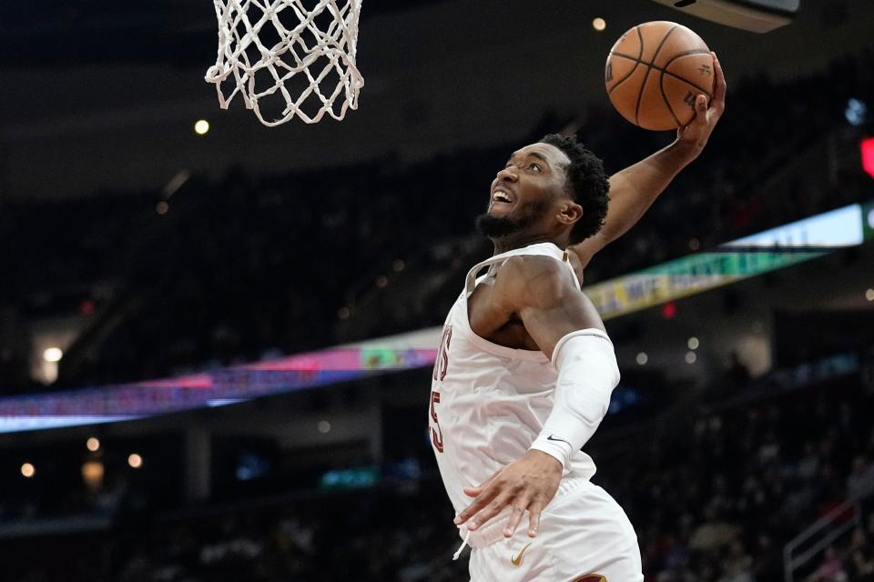 Cleveland Cavaliers guard Donovan Mitchell goes up for a dunk in the second half of an NBA basketball game against the Sacramento Kings, Monday, Feb. 5, 2024, in Cleveland. (AP Photo/Sue Ogrocki)