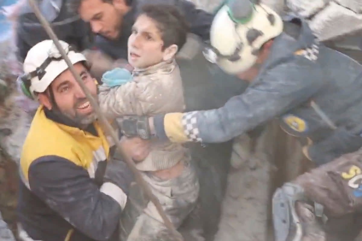 The White Helmet volunteers rescue a child from under rubble, in the aftermath of a deadly earthquake, in Jandaris, Syria (THE WHITE HELMETS via REUTERS)