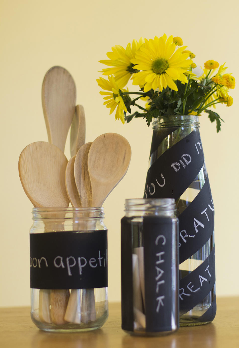 This May 21, 2012, photo in Concord, N.H., shows recycled jars and bottles decorated with chalkboard spray paint. (AP Photo/Holly Ramer)