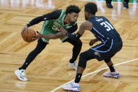 Boston Celtics guard Marcus Smart (36) makes a move against Orlando Magic guard Terrence Ross (31) during the first half of an NBA basketball game Friday, Jan. 15, 2021, in Boston. (AP Photo/Elise Amendola)