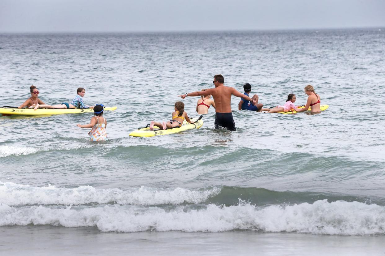 Lifeguards at Hampton Beach give young swimmers a chance to ride on safety boards as part of Water Safety Day Thursday, July 27, 2023.