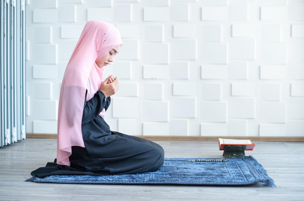 Muslim students may request special accommodations during the Islamic month of fasting. <a href="https://www.gettyimages.com/detail/photo/side-view-of-asian-beautiful-young-muslim-student-royalty-free-image/1213143339?phrase=Muslim%20students%20pray&adppopup=true" rel="nofollow noopener" target="_blank" data-ylk="slk:mkitina4 via Getty Images;elm:context_link;itc:0;sec:content-canvas" class="link ">mkitina4 via Getty Images</a>