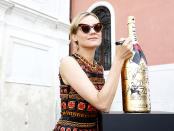 <p>The movie star signed an oversize bottle of bubbly at the European filmmakers lunch during the Venice Film Festival. (Photo: Ernesto Ruscio/Getty Images) </p>