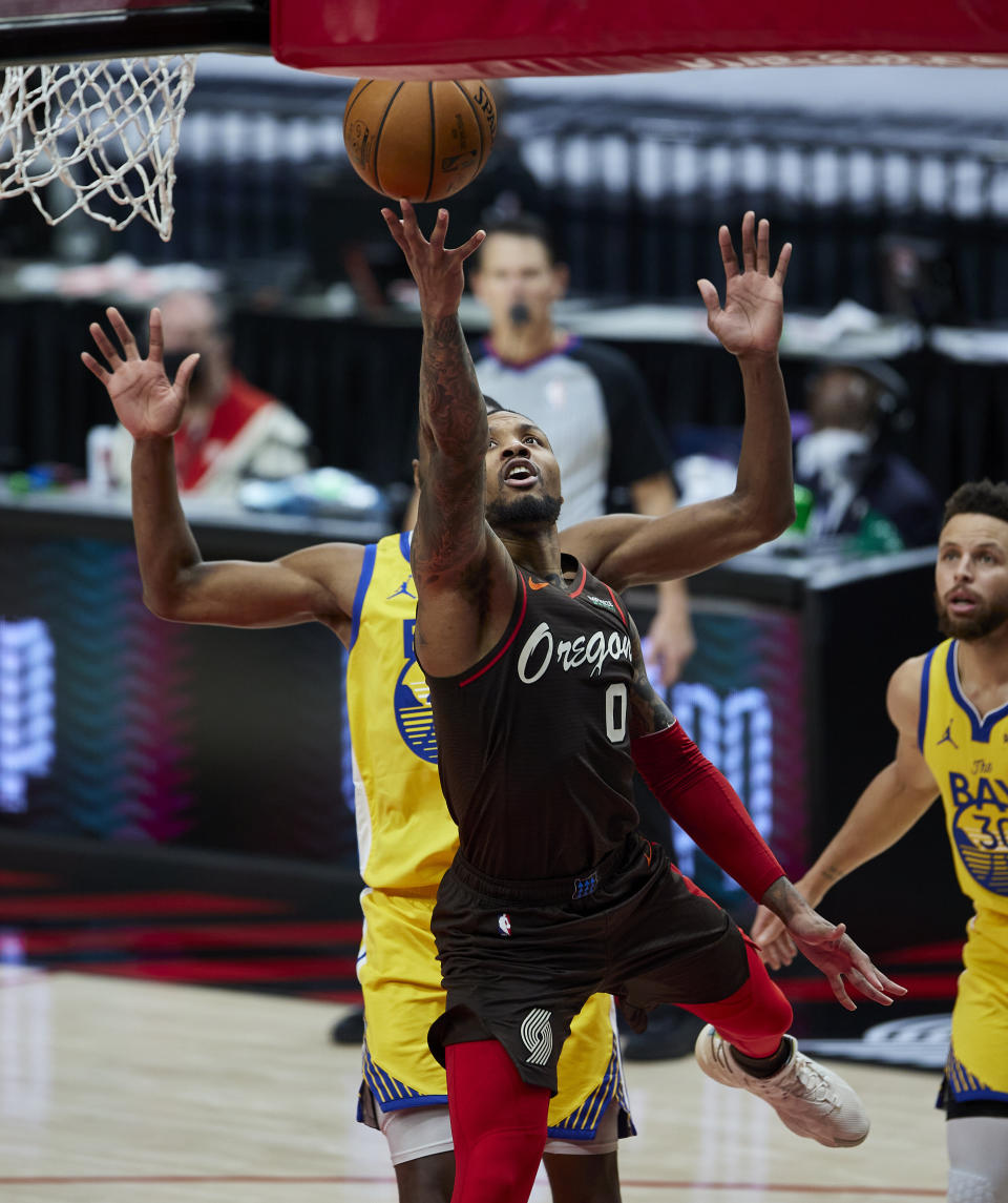 Portland Trail Blazers guard Damian Lillard scores against the Golden State Warriors during the second half of an NBA basketball game in Portland, Ore., Wednesday, March 3, 2021. (AP Photo/Craig Mitchelldyer)